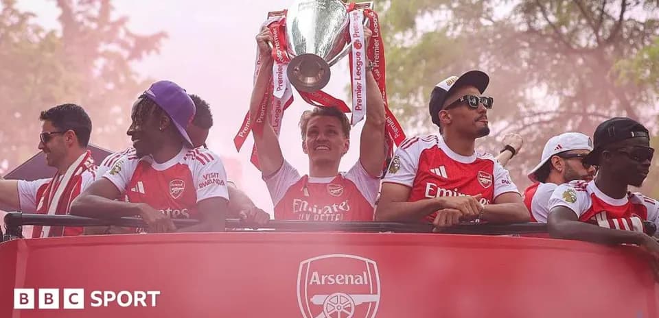 Players celebrating with Premier League trophy on parade