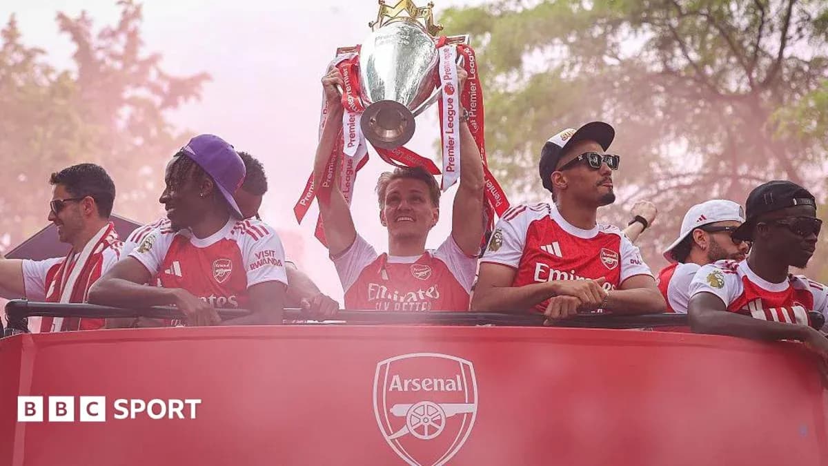 Players celebrating with Premier League trophy on parade