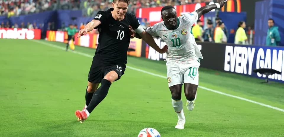 Two players competing for the ball on the field