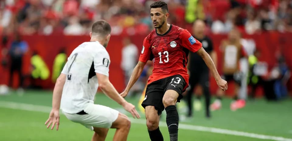 Player dribbling past opponent during match