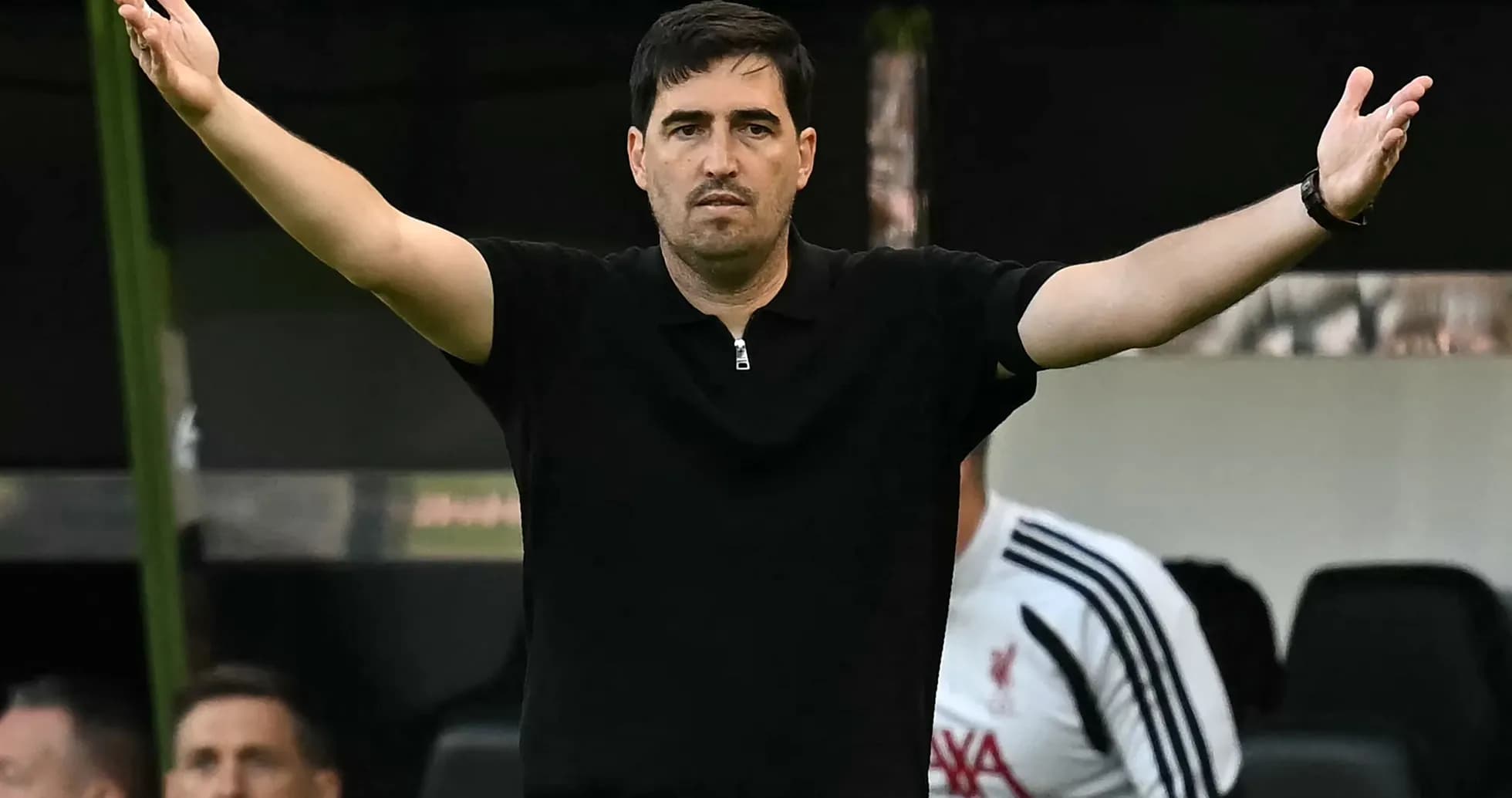 Coach gesturing during a match from the sidelines