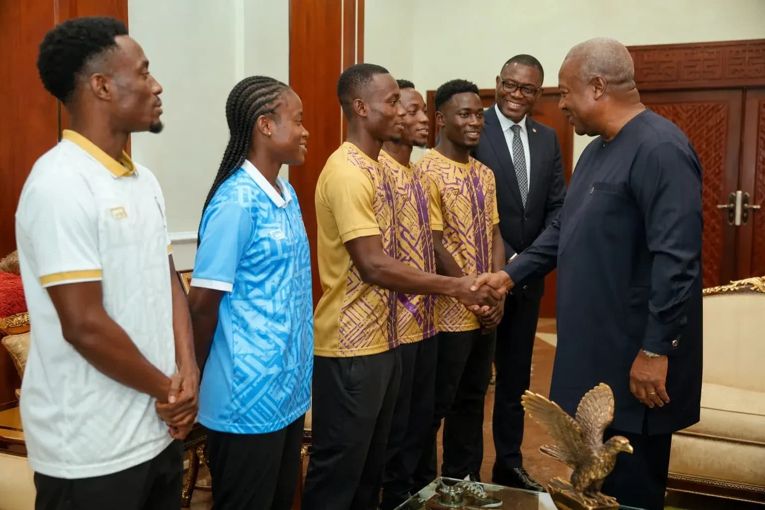 Athletes meeting official in formal setting