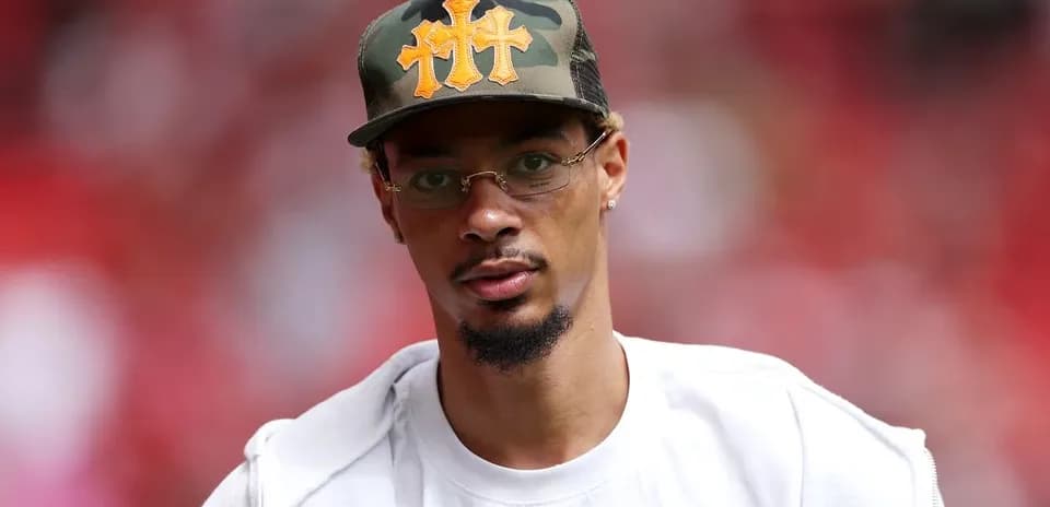 Person wearing a camo cap and glasses