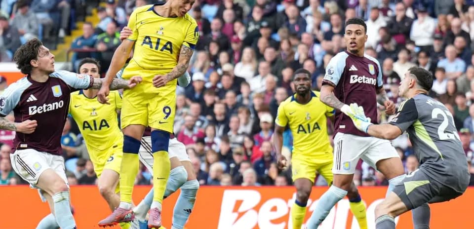 Tottenham player heading the ball against Aston Villa