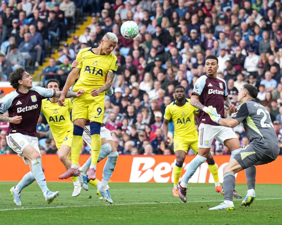 Tottenham player heading the ball against Aston Villa