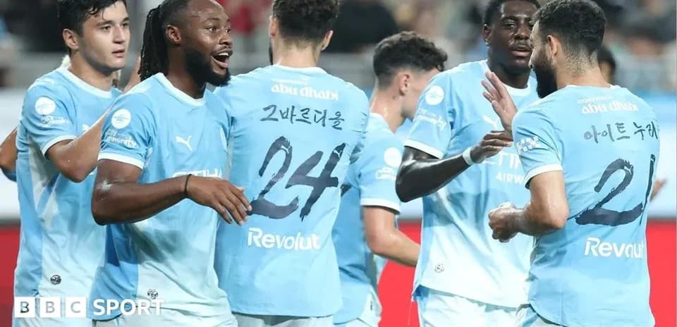 Players celebrating together in light blue jerseys