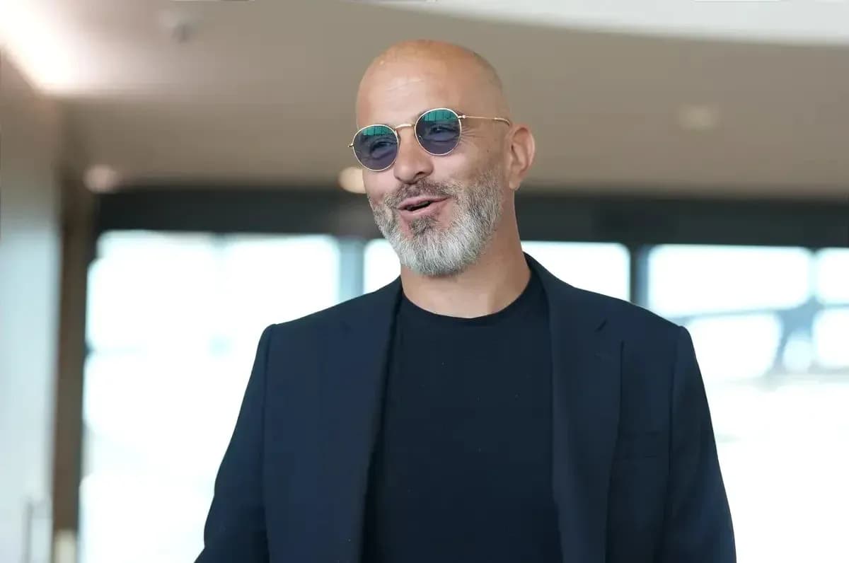 Man in sunglasses smiling in modern indoor setting