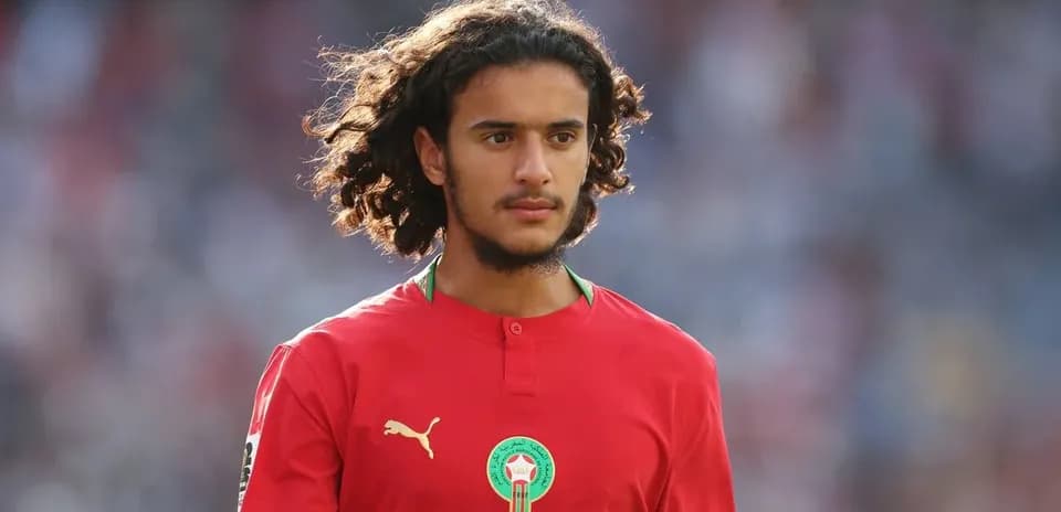Player wearing red Morocco jersey on field