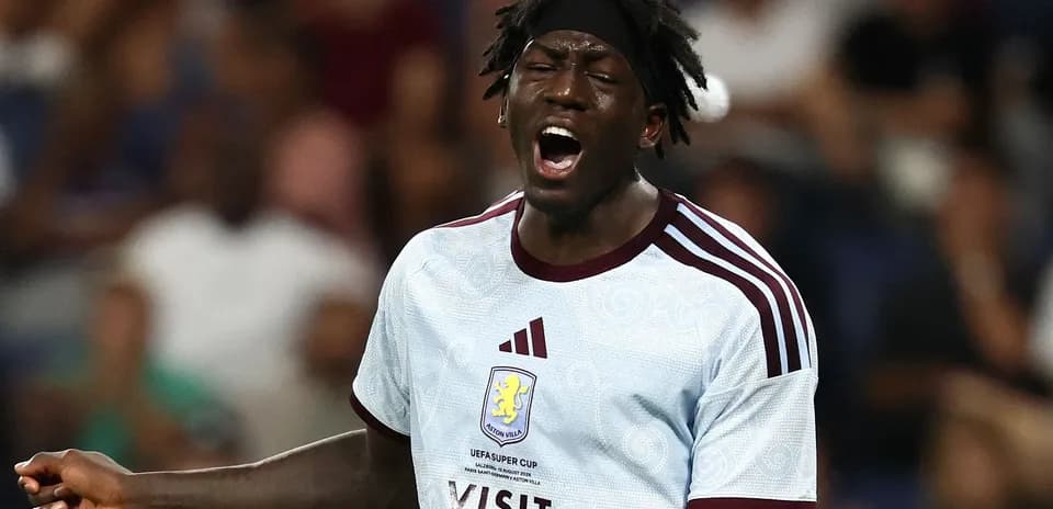 Player shouting during match wearing Aston Villa jersey