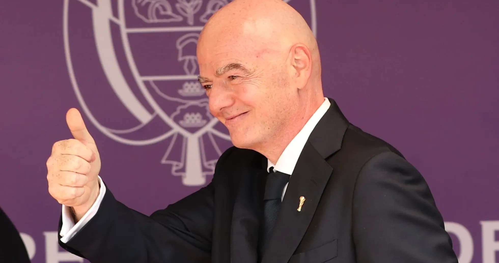 Man giving thumbs up at formal event