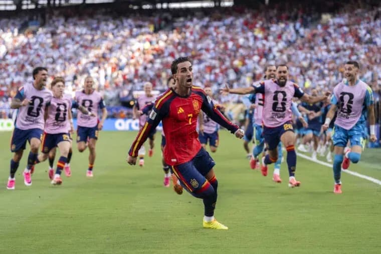 Spain player celebrating goal with teammates during match