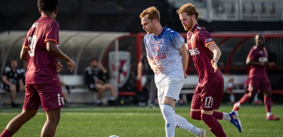 Players competing for the ball in USL match