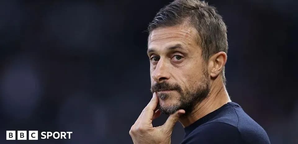 Coach observing match with hand on chin