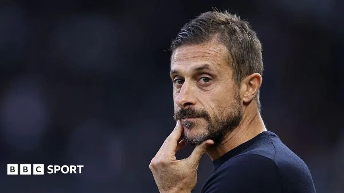 Coach observing match with hand on chin