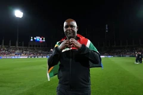 Coach wearing South African flag on the field
