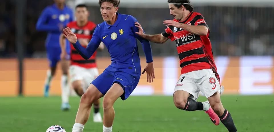 Player in blue dribbling past opponent in red