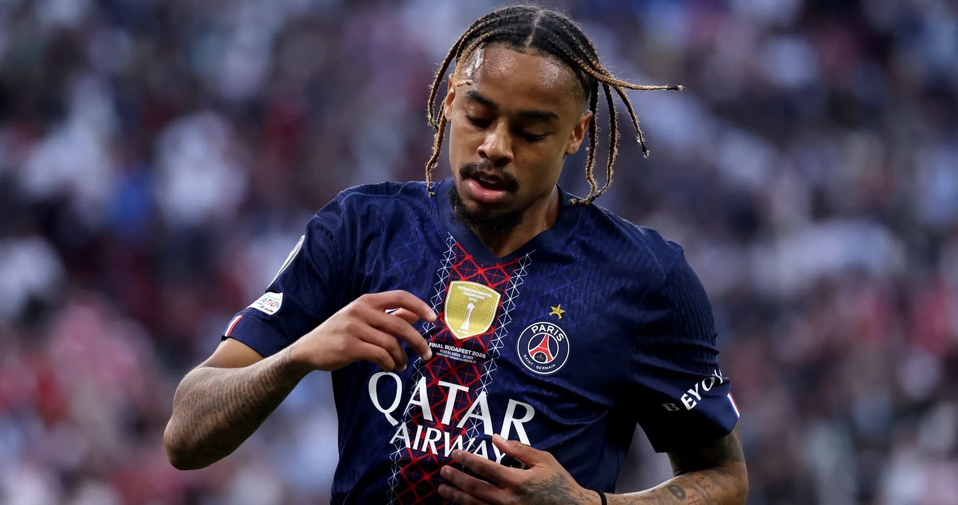 Player adjusting PSG badge on match jersey