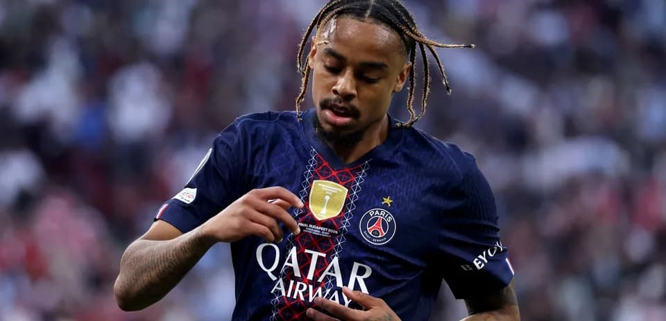 Player adjusting PSG badge on match jersey
