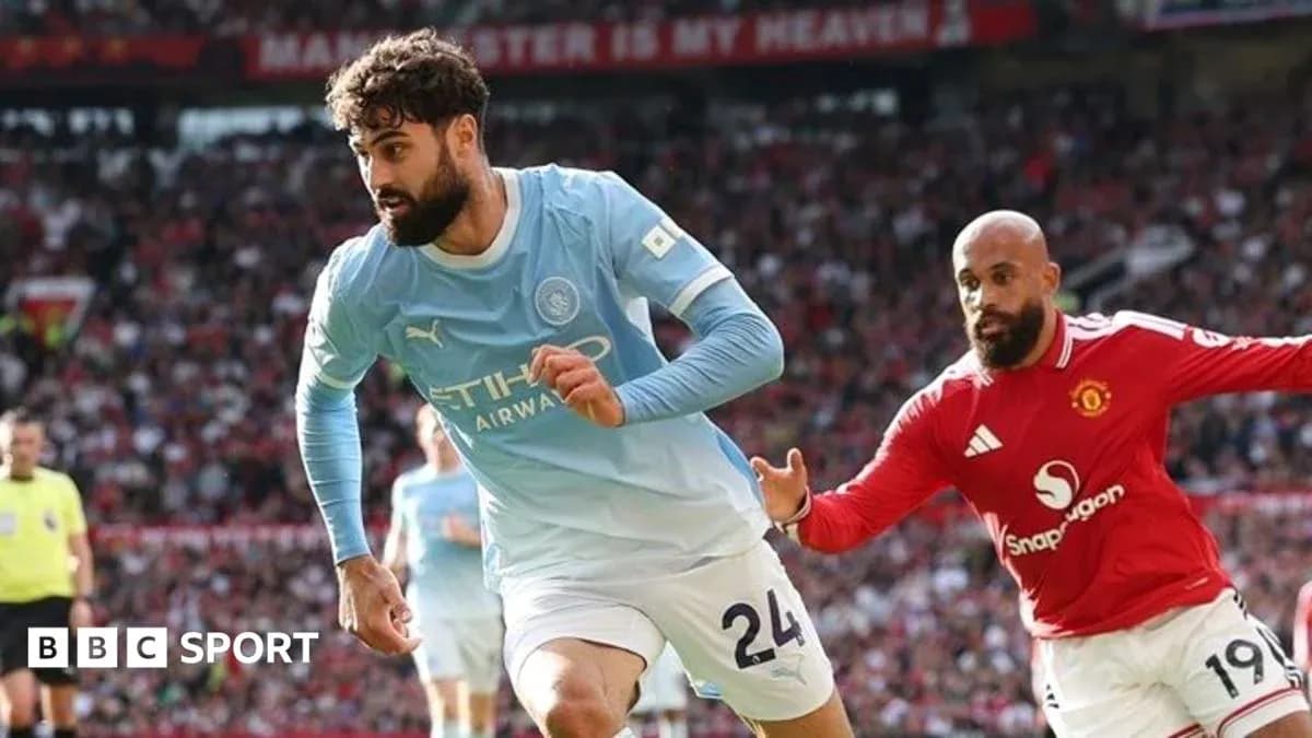 Manchester City player sprinting with ball against Manchester United Manchester City player sprinting with ball against Manchester United