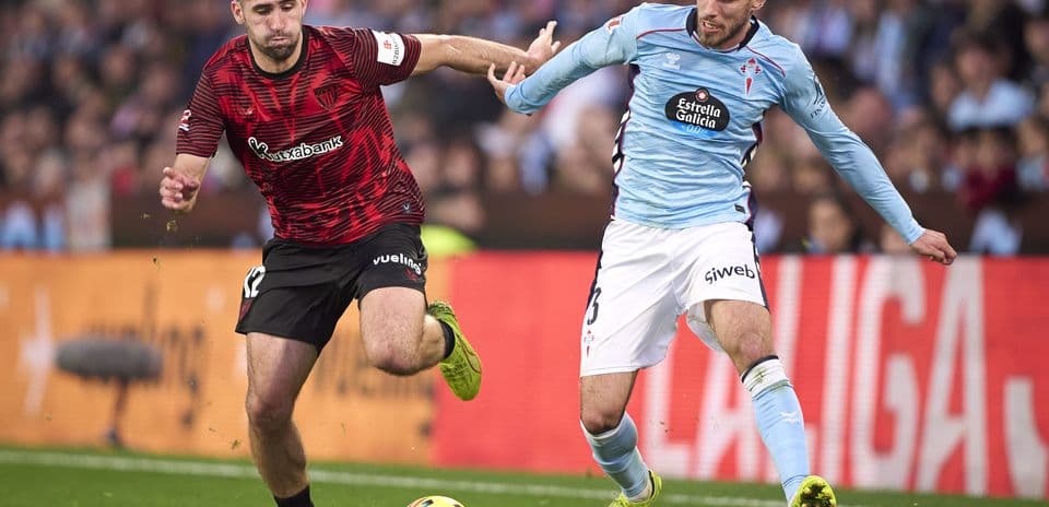 Athletic Club player challenging Celta Vigo opponent