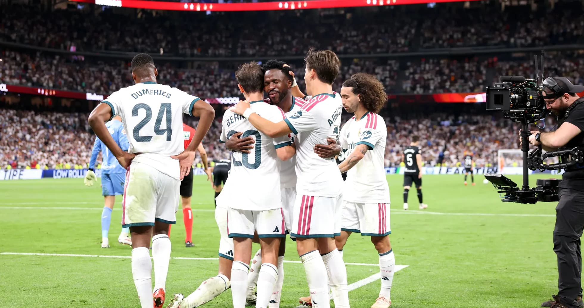 Players celebrating a goal on the field