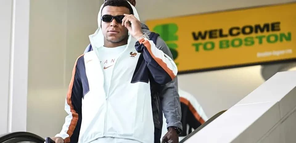 Player arriving at airport escalator in Boston
