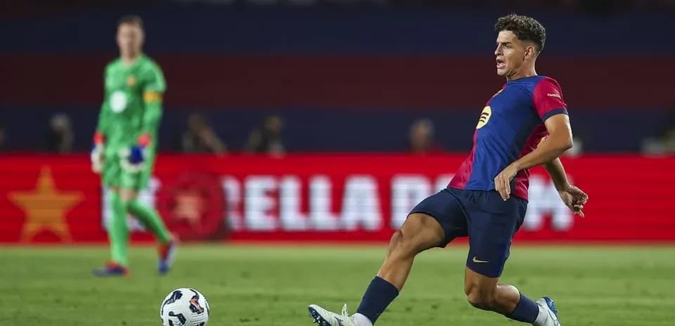 Player kicking ball during match with goalkeeper behind