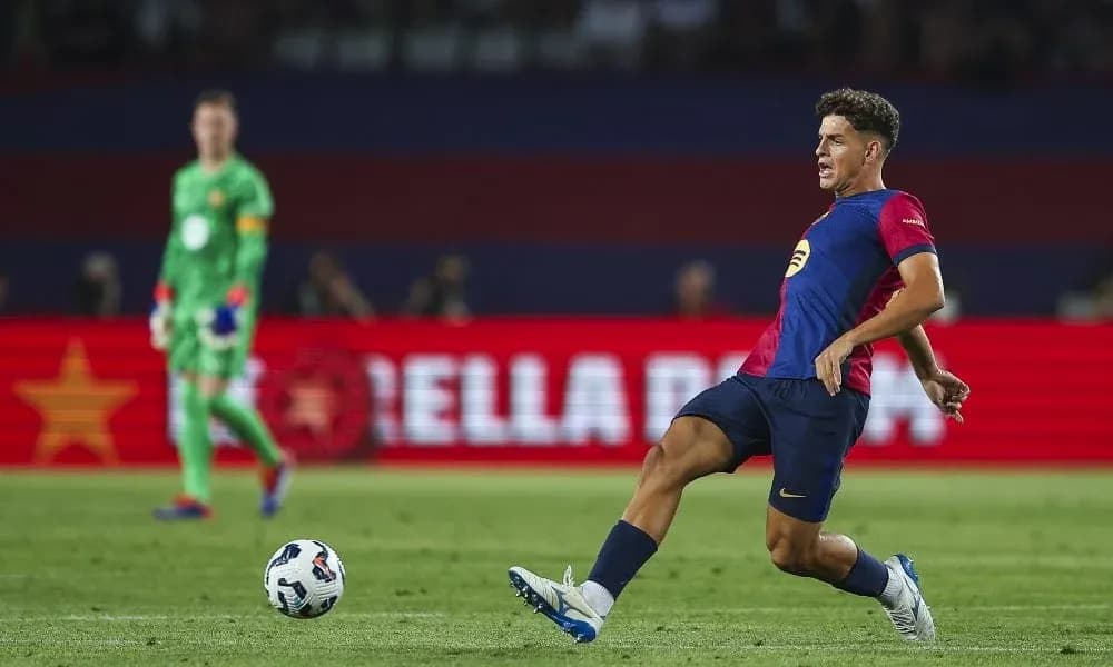 Player kicking ball during match with goalkeeper behind