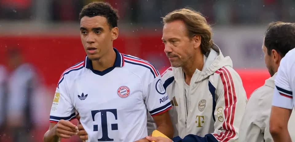 Player receiving instructions from coach on sidelines