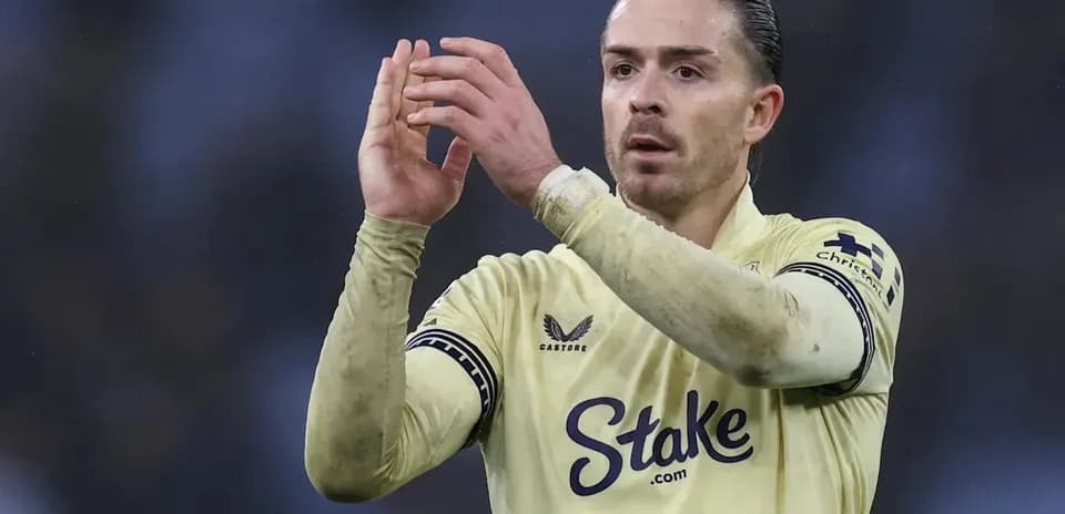 Player applauding fans while wearing yellow jersey