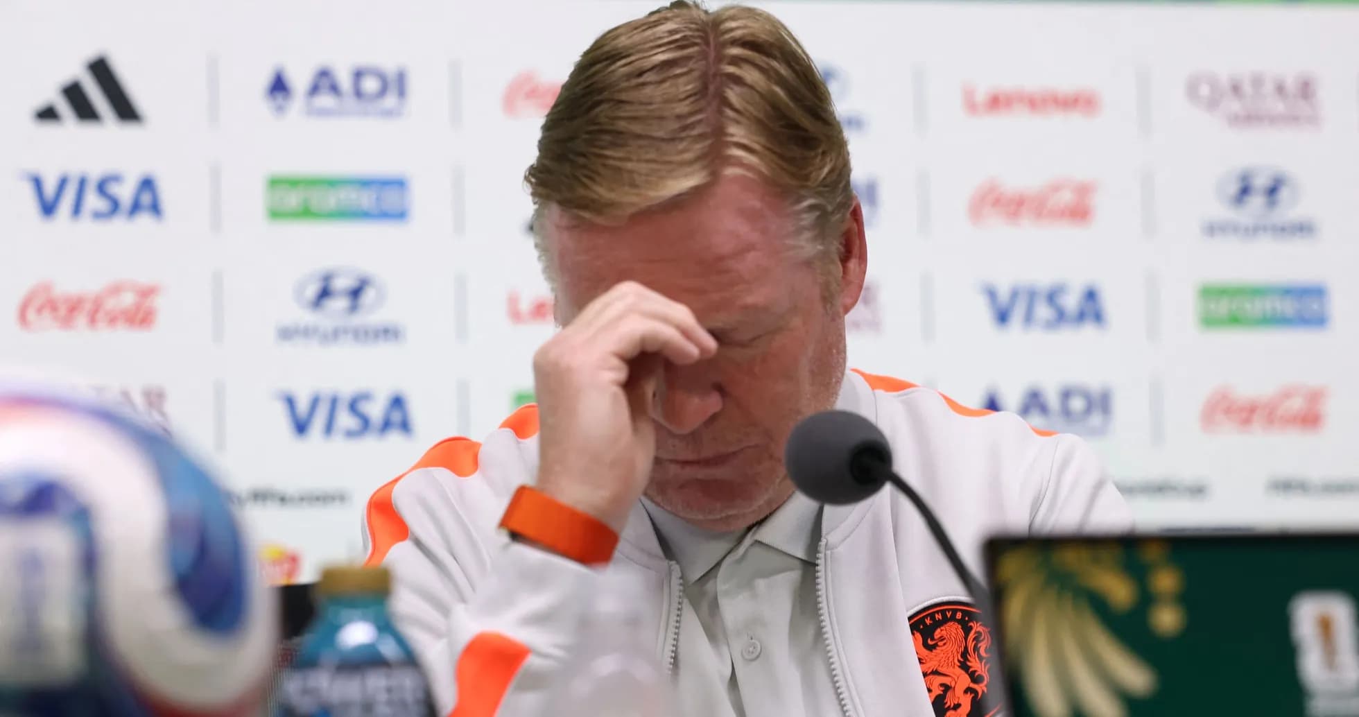 Manager at press conference with hand on forehead