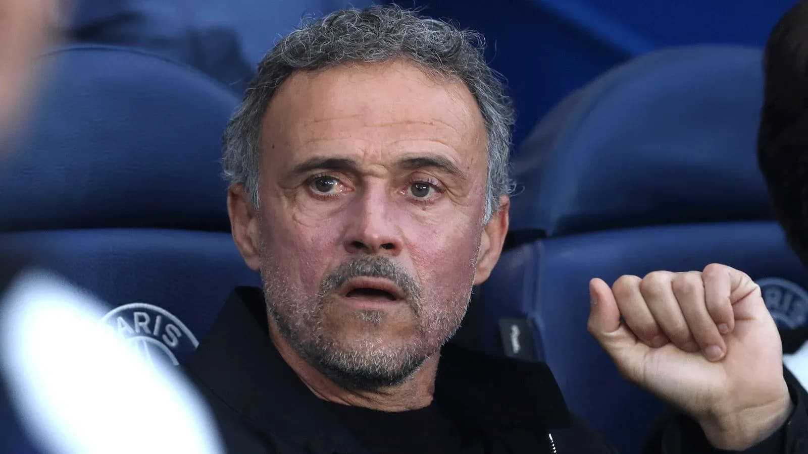 Coach observing from the bench during a match