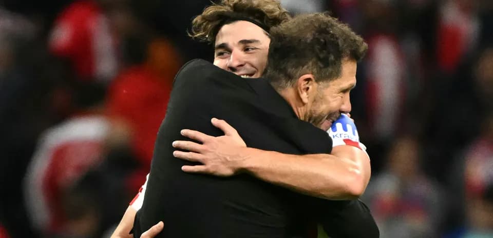 Player and coach embracing after match victory