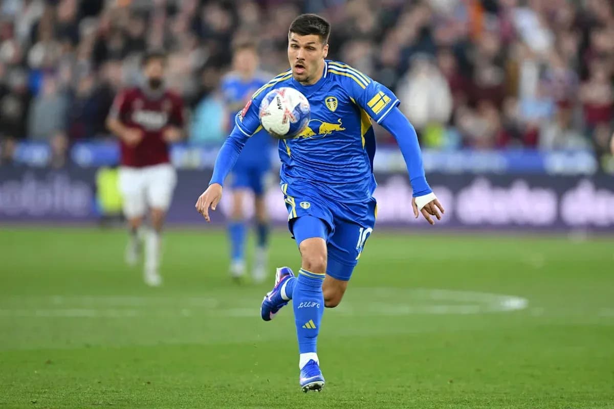 Player in blue kit dribbling the ball on field