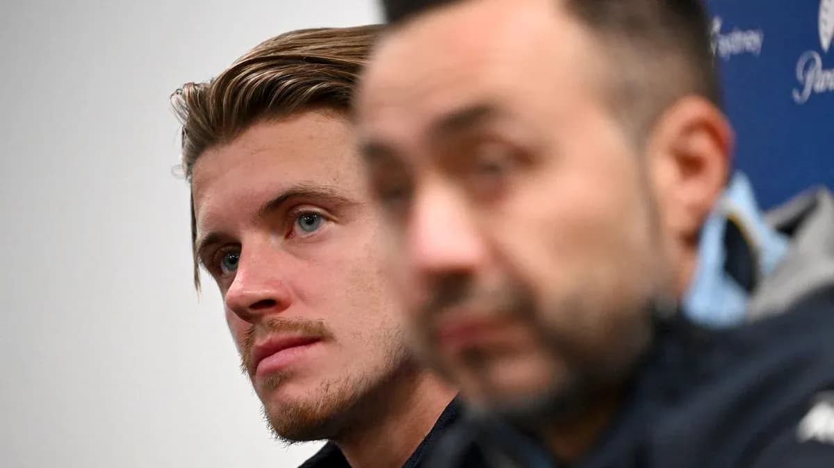 Two individuals at a press conference backdrop