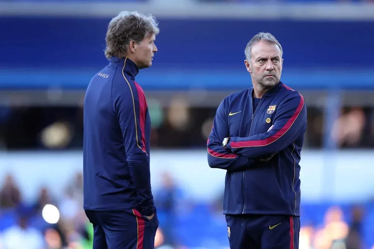 Two coaches discussing strategies on the pitch