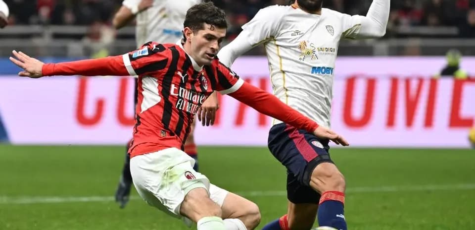 AC Milan player tackling Cagliari opponent
