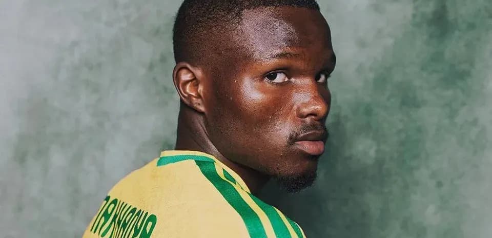 Player in yellow jersey looking over shoulder