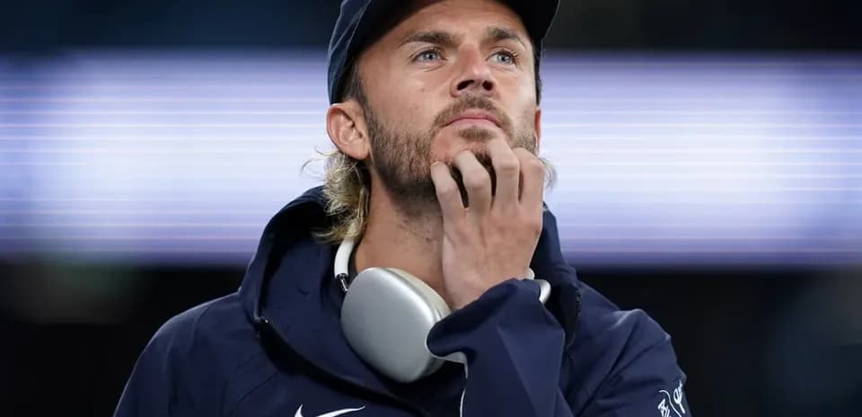 Person wearing headphones looking thoughtfully ahead