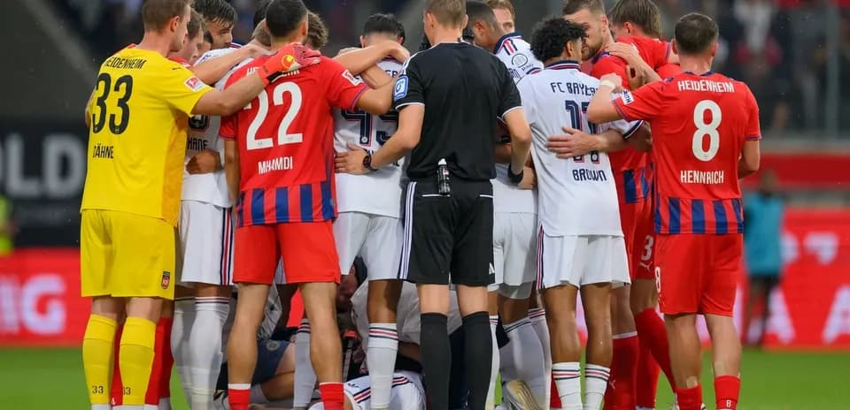 Players from both teams gathered around a fallen player