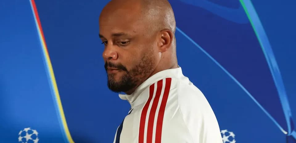 Manager walking past Champions League backdrop