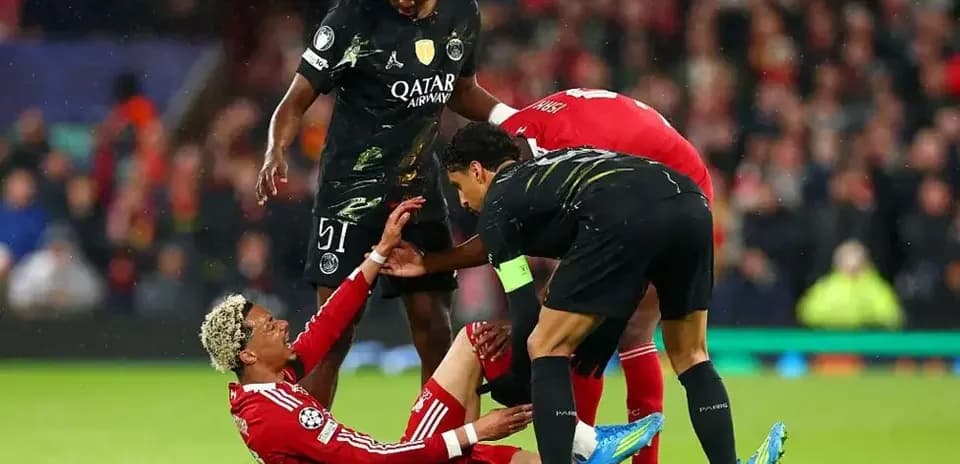 Players assisting fallen teammate during match action