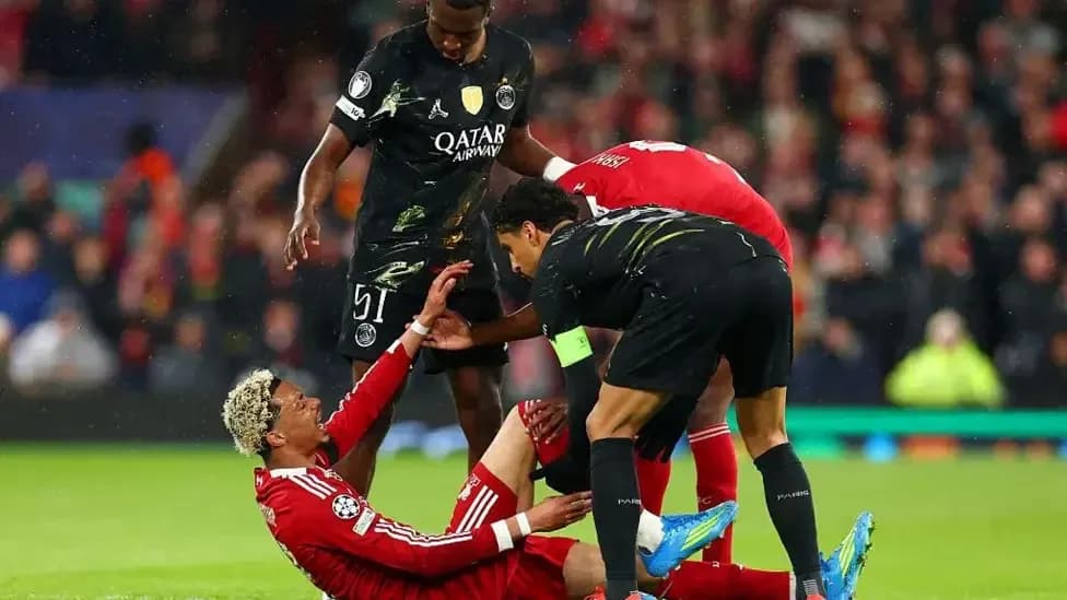 Players assisting fallen teammate during match action