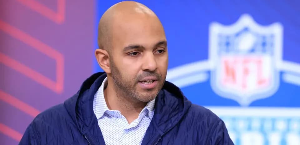 Person speaking at NFL event backdrop