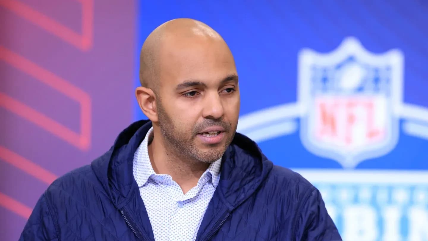 Person speaking at NFL event backdrop