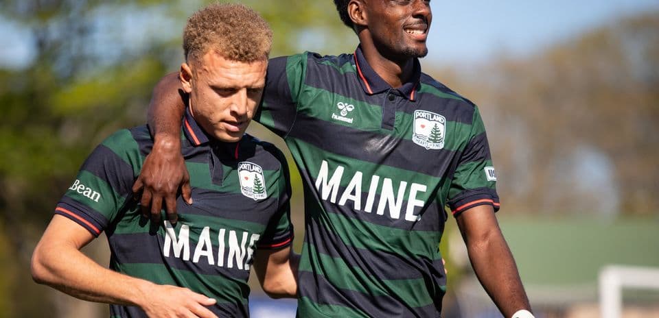 Two players from Portland Hearts of Pine celebrating