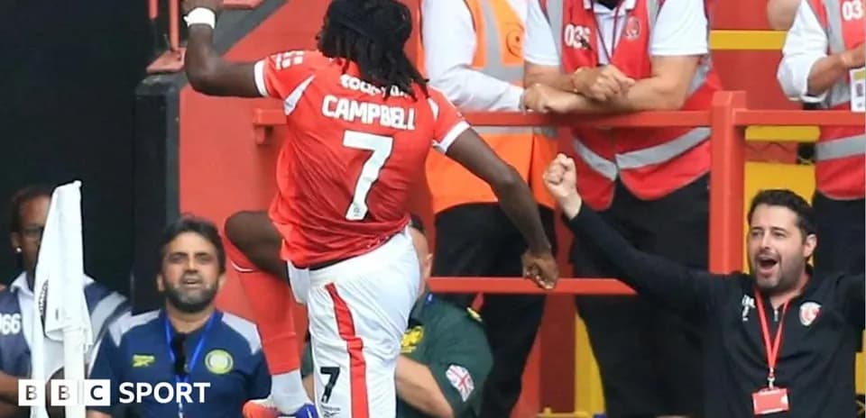 Player celebrating a goal in front of fans