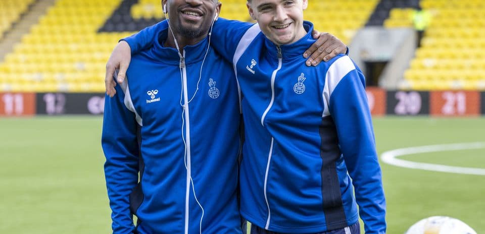 Two players posing together on the field