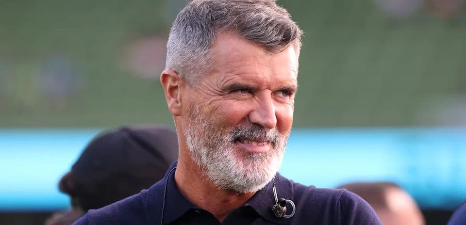 Man with gray beard smiling during event