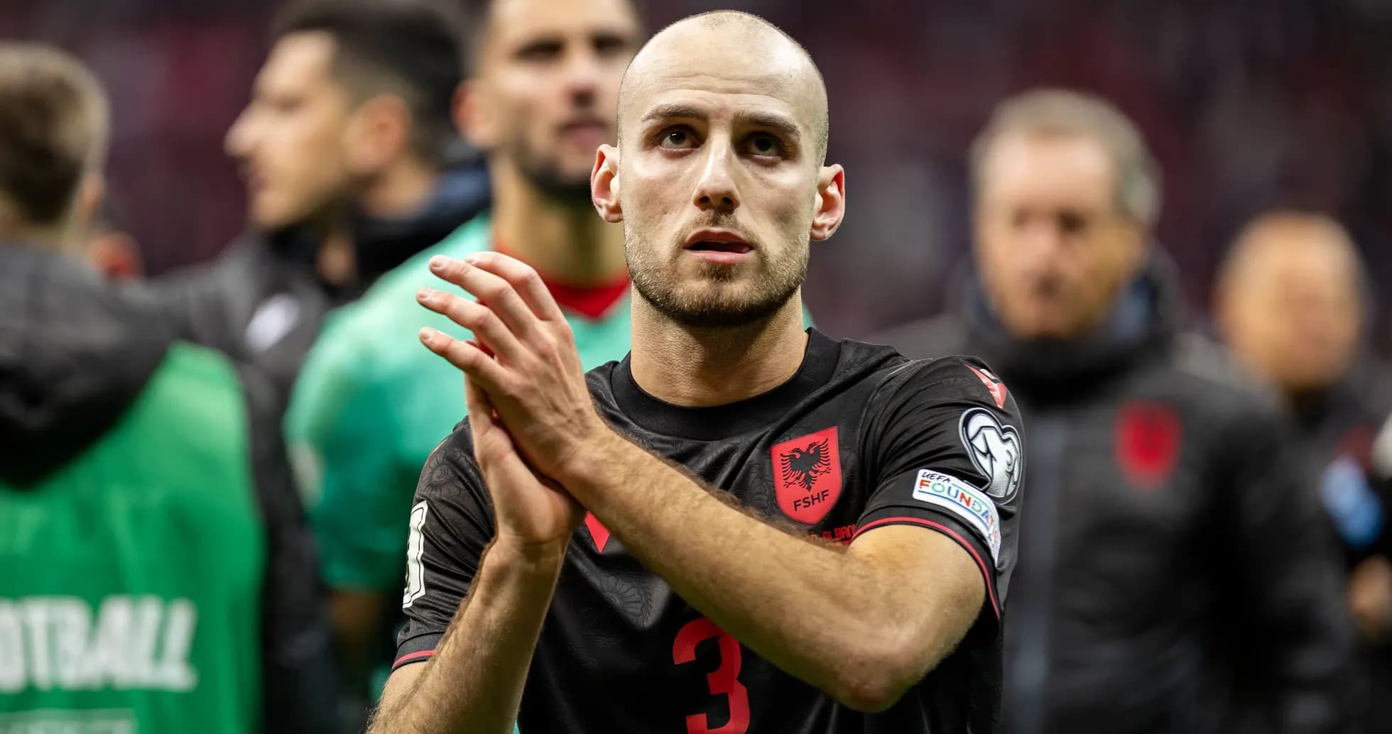 Albanian player applauding fans after match